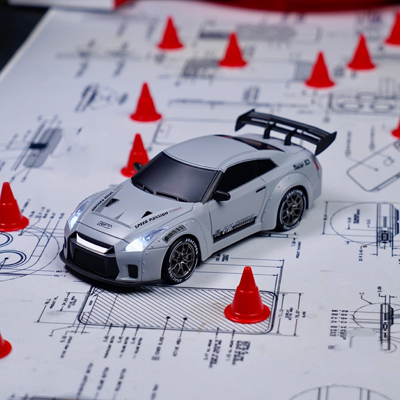 Model car on technical drawings with red cones