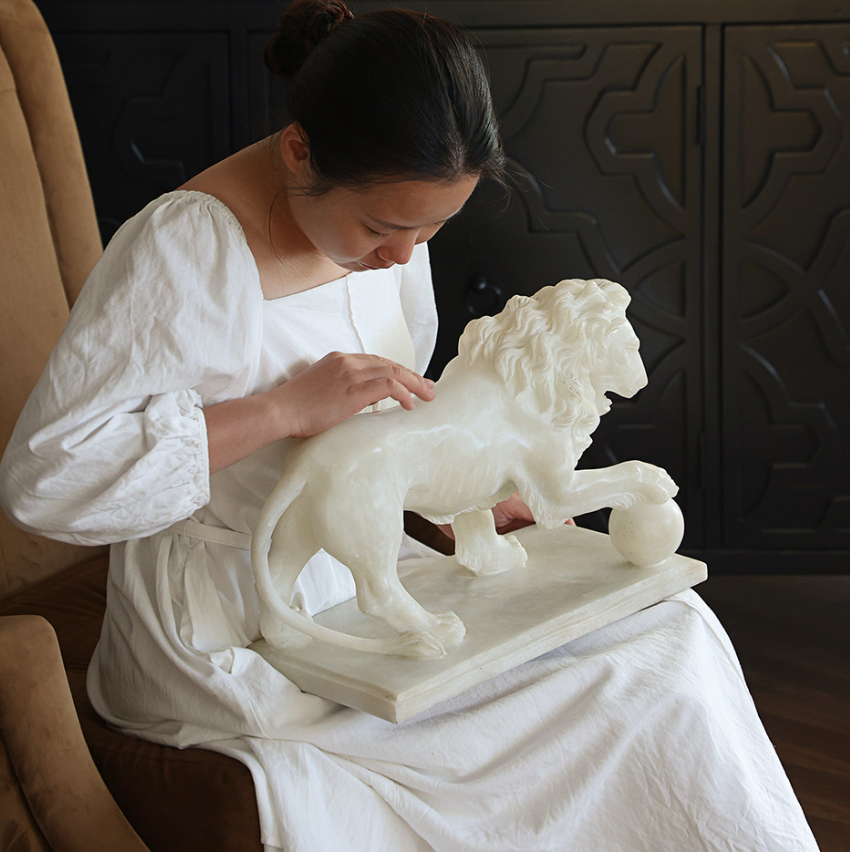 Artistic Lion Sculpture With A Rolling Fortune And Embroidered Ball Underfoot — image 1