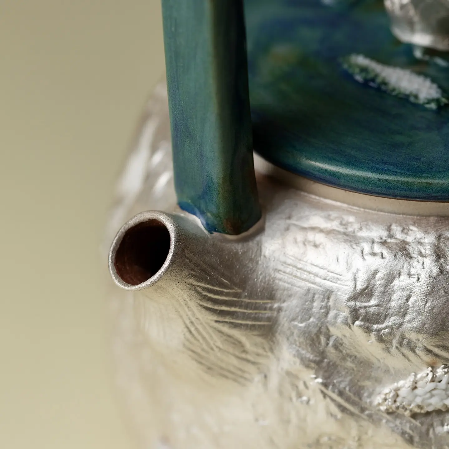 A Handcrafted Stoneware Teapot With A Handle Elegantly Dressed In Silver And White