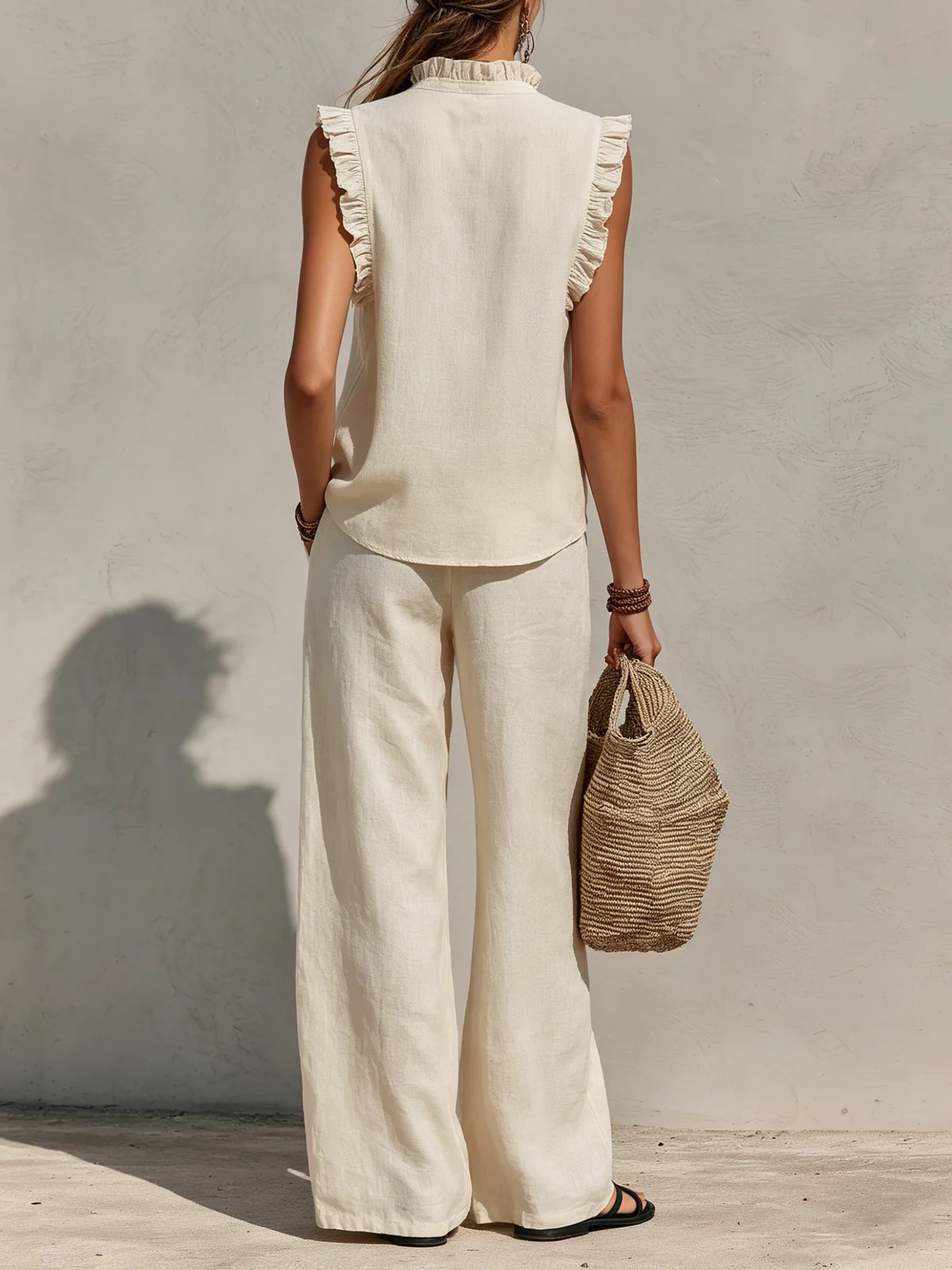 Women's sleeveless ruffle top and wide-leg pants set in black – elegant casual style