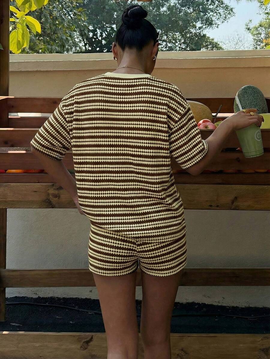 Women's spliced shorts set in black, side view showing T-shirt and shorts coordination
