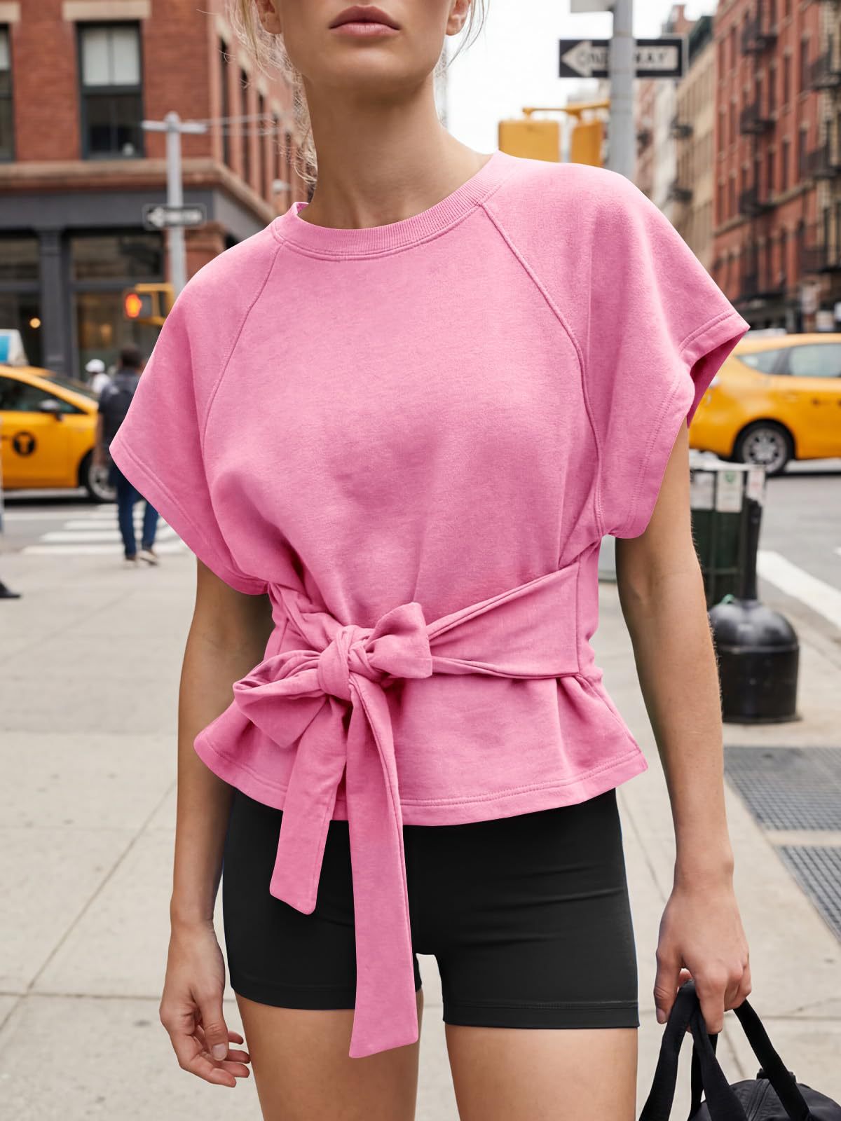 Women's lace-up top in pink, close-up of bow-knot tie detail