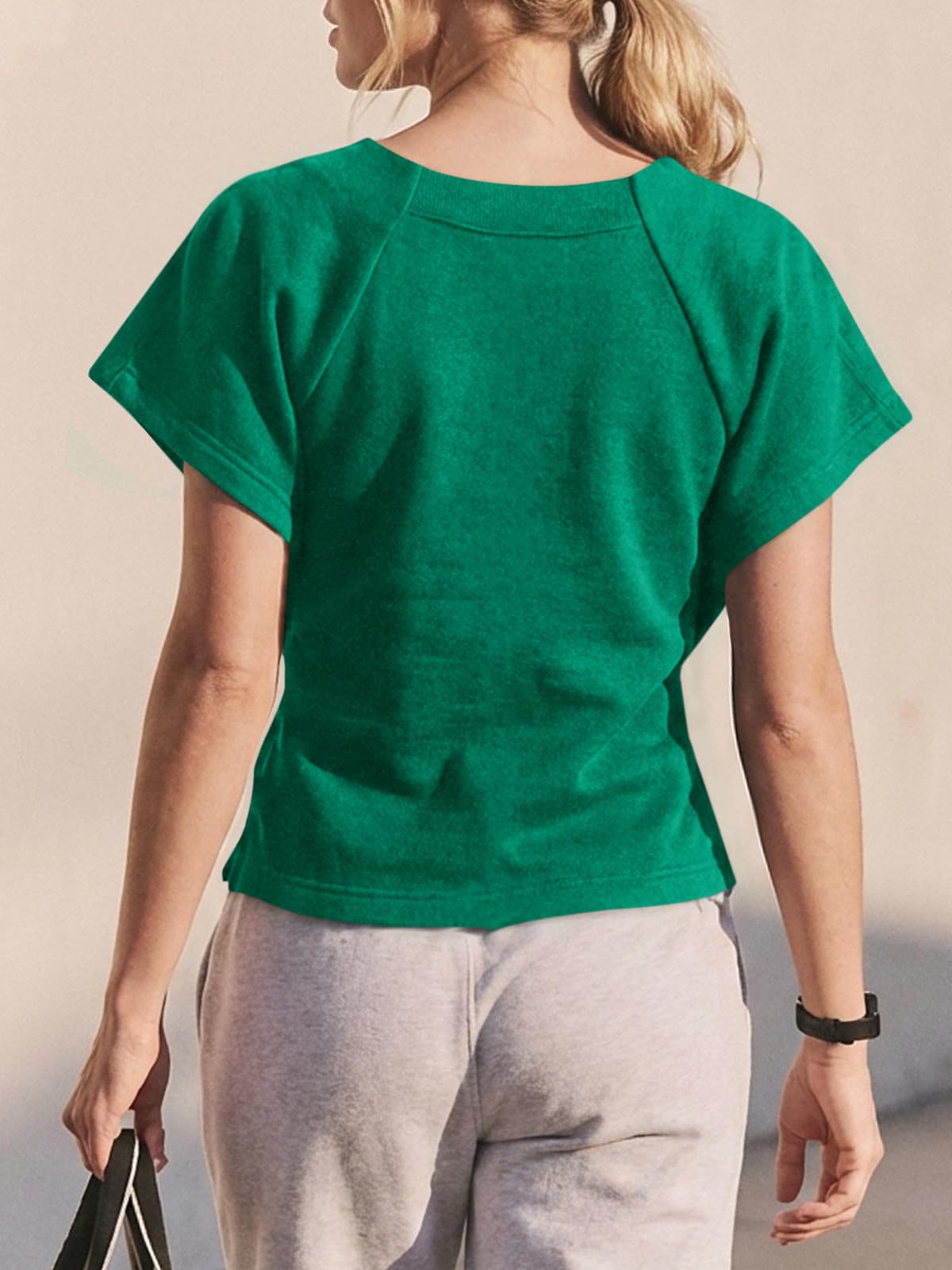 Women's loose bow-knot top in green, casual lifestyle photo showing relaxed fit
