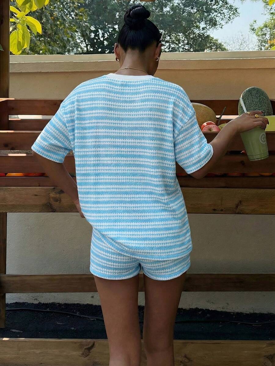Women's spliced T-shirt shorts set detail shot showing crew neckline and fabric drape