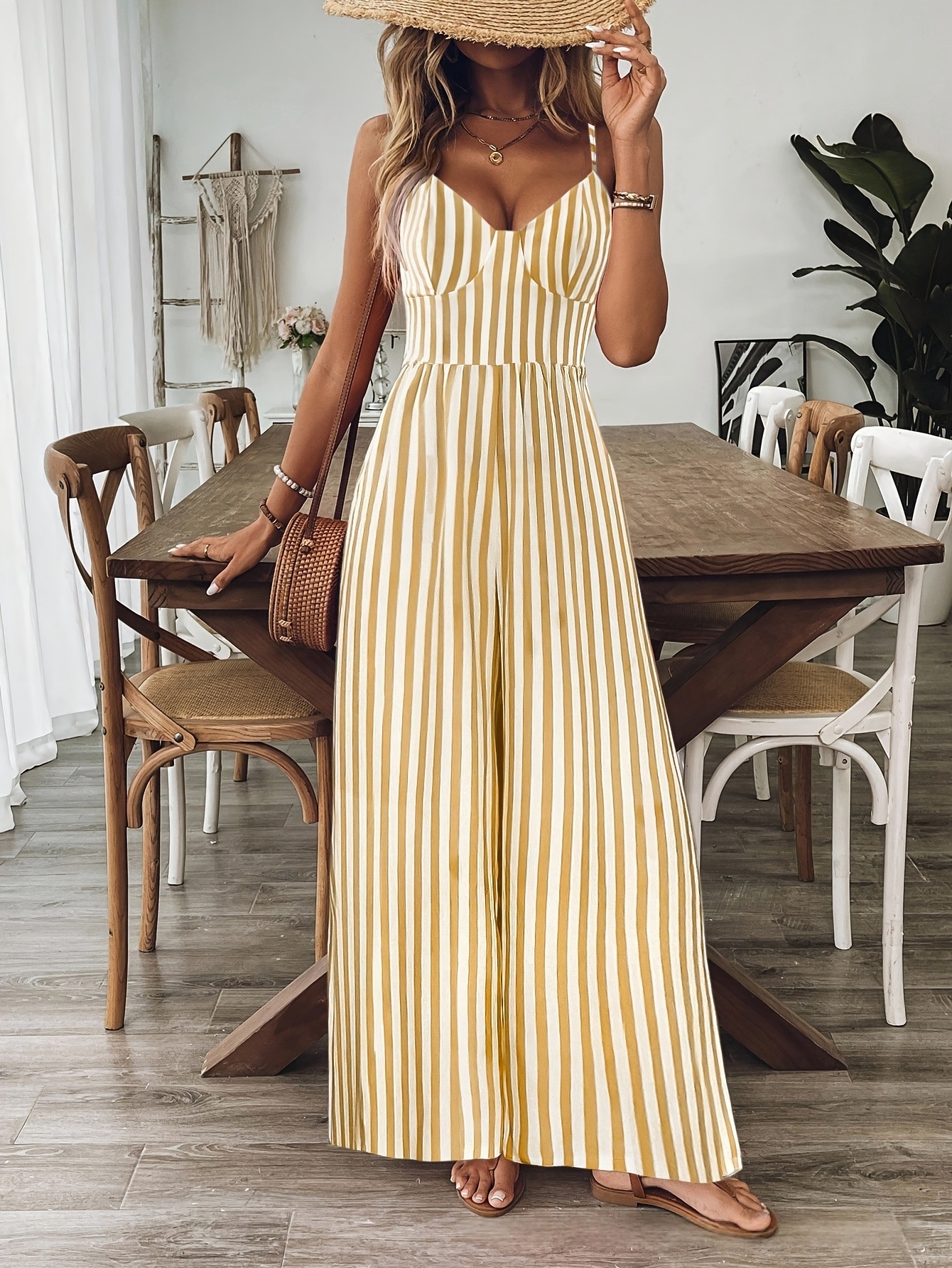 Printed backless sleeveless jumpsuit in ginger yellow, final lifestyle photo showing complete look