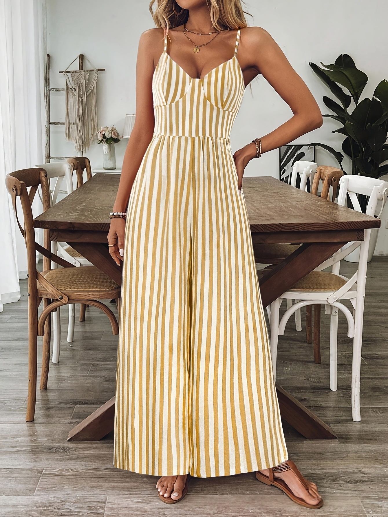 Ginger yellow strap jumpsuit, model wearing lifestyle detail shot showing print pattern and strap design