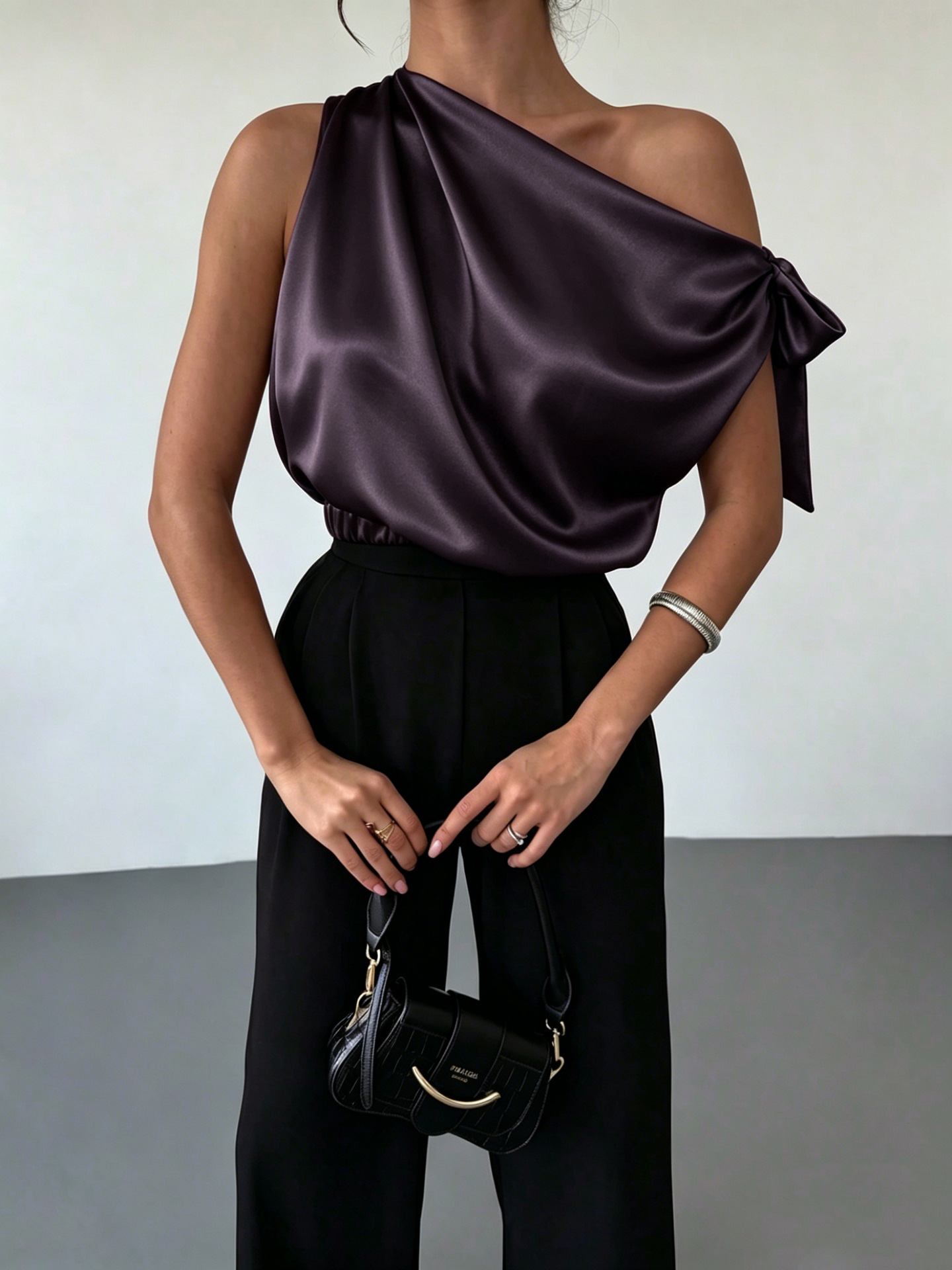 Women's satin bow blouse in White – off-shoulder asymmetrical top, front view showing satin fabric drape