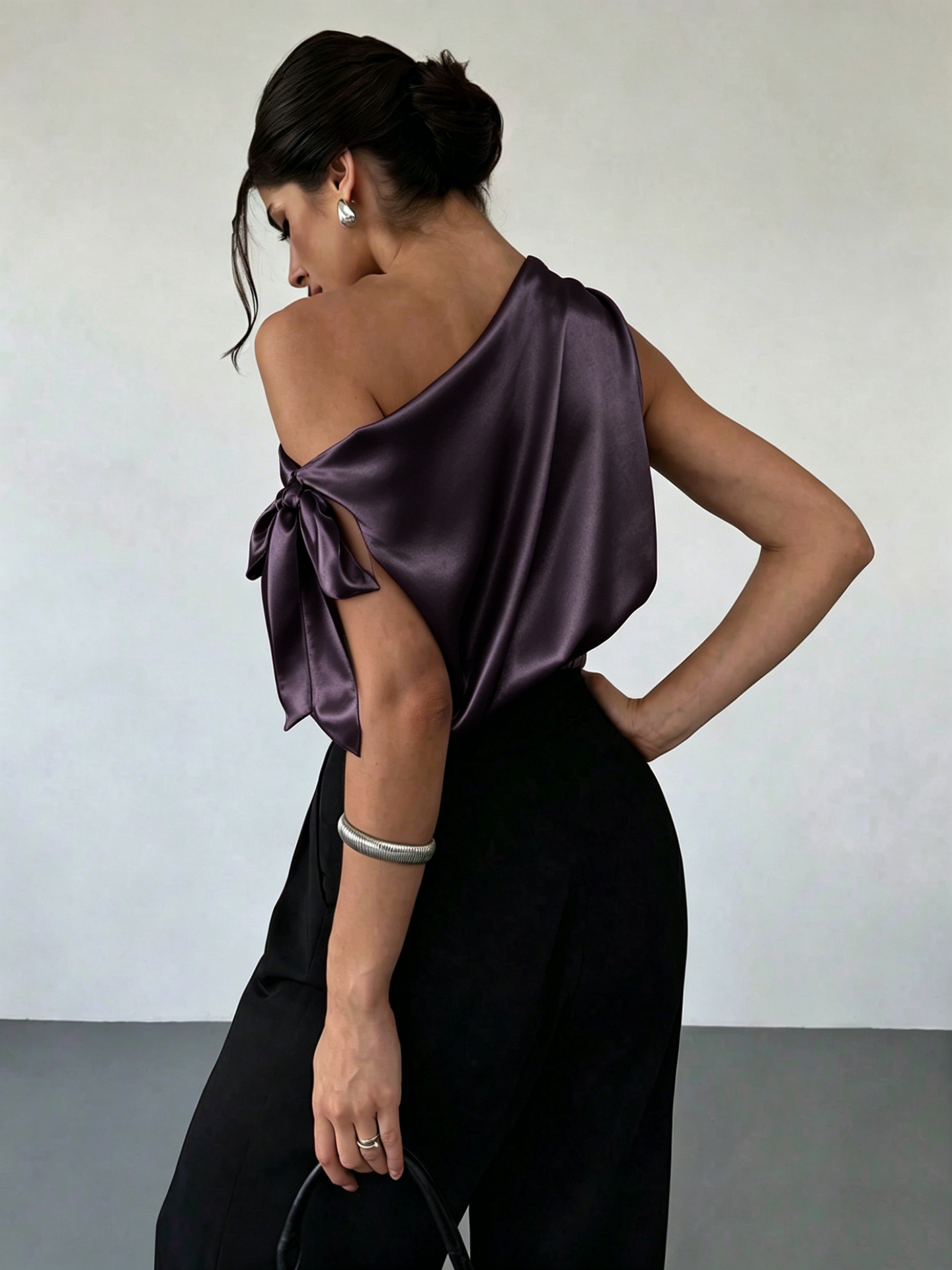 Women's satin off-shoulder blouse in Dark Purple – asymmetrical bow top styled for evening out