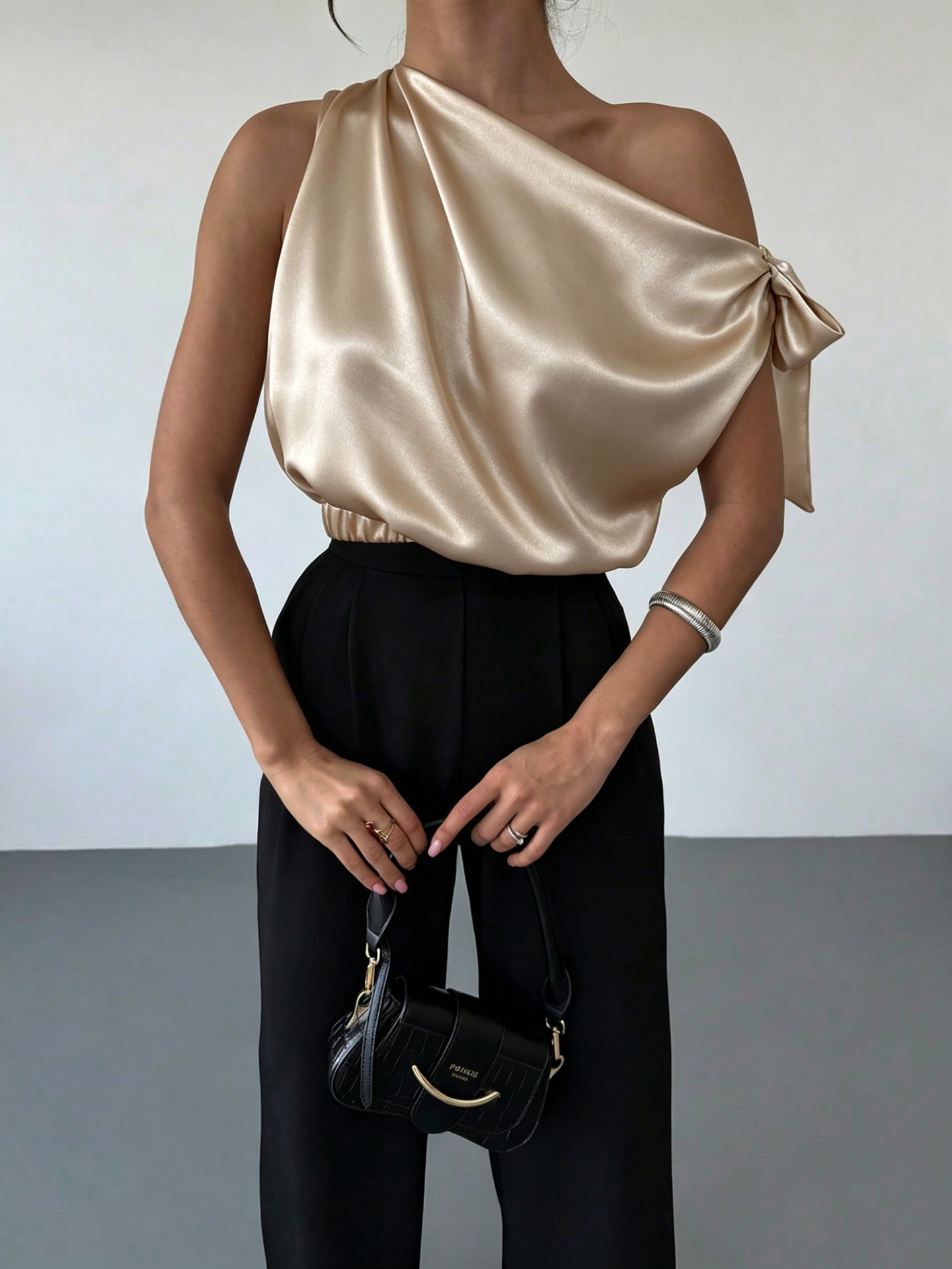 Women's satin off-shoulder blouse in Dark Purple – asymmetrical bow top styled for elevated casual with wide-leg jeans