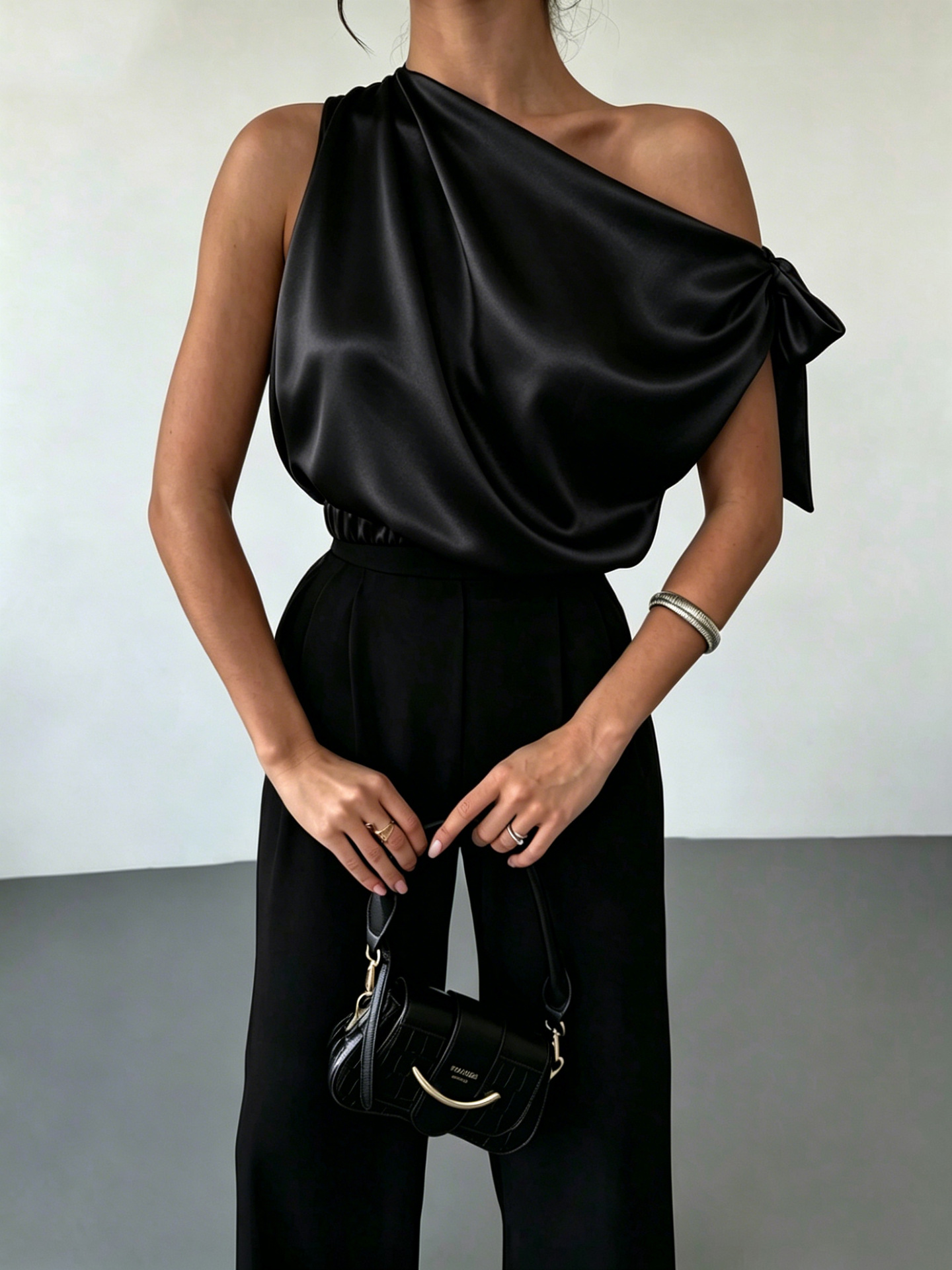 Women's satin bow blouse in Apricot – off-shoulder top, side view showing asymmetrical hem and satin drape