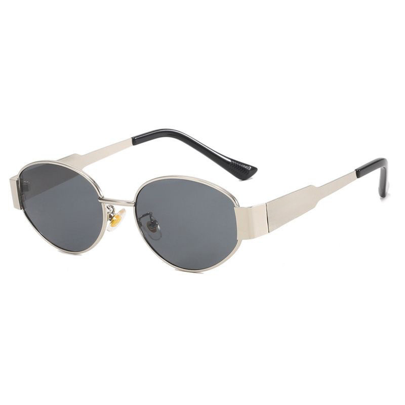 Close-up of vintage oval sunglasses frame and lens detail showing light luxury craftsmanship