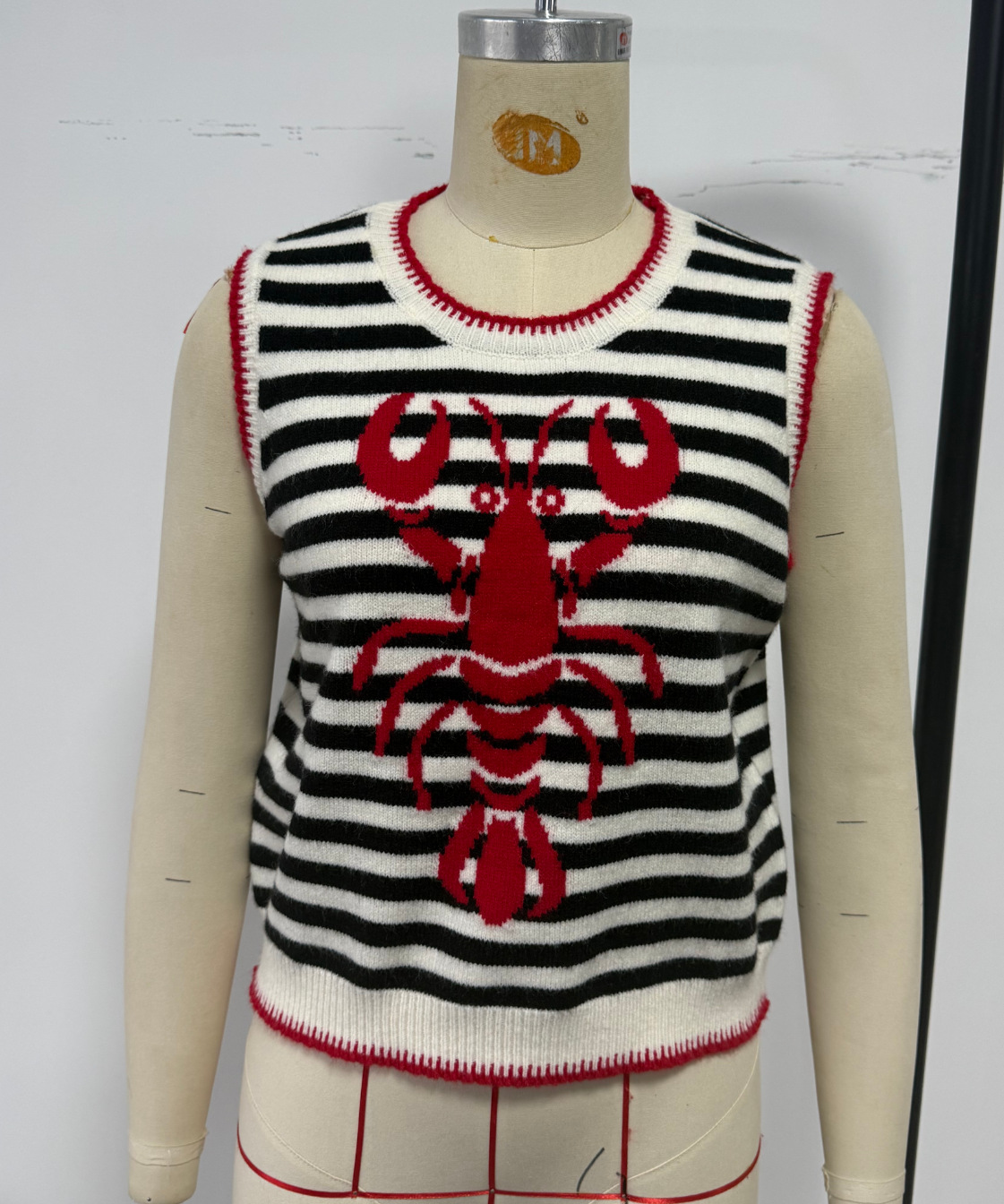 Women's jacquard knit vest in Dark Red – lifestyle editorial photo for resort and vacation styling