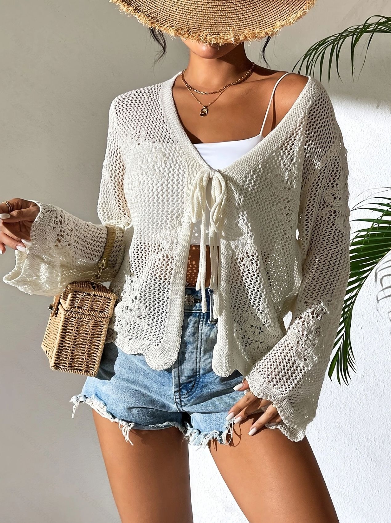 Women's open knit lace-up cardigan in Sky Blue – styled as beach cover-up over bikini, vacation look