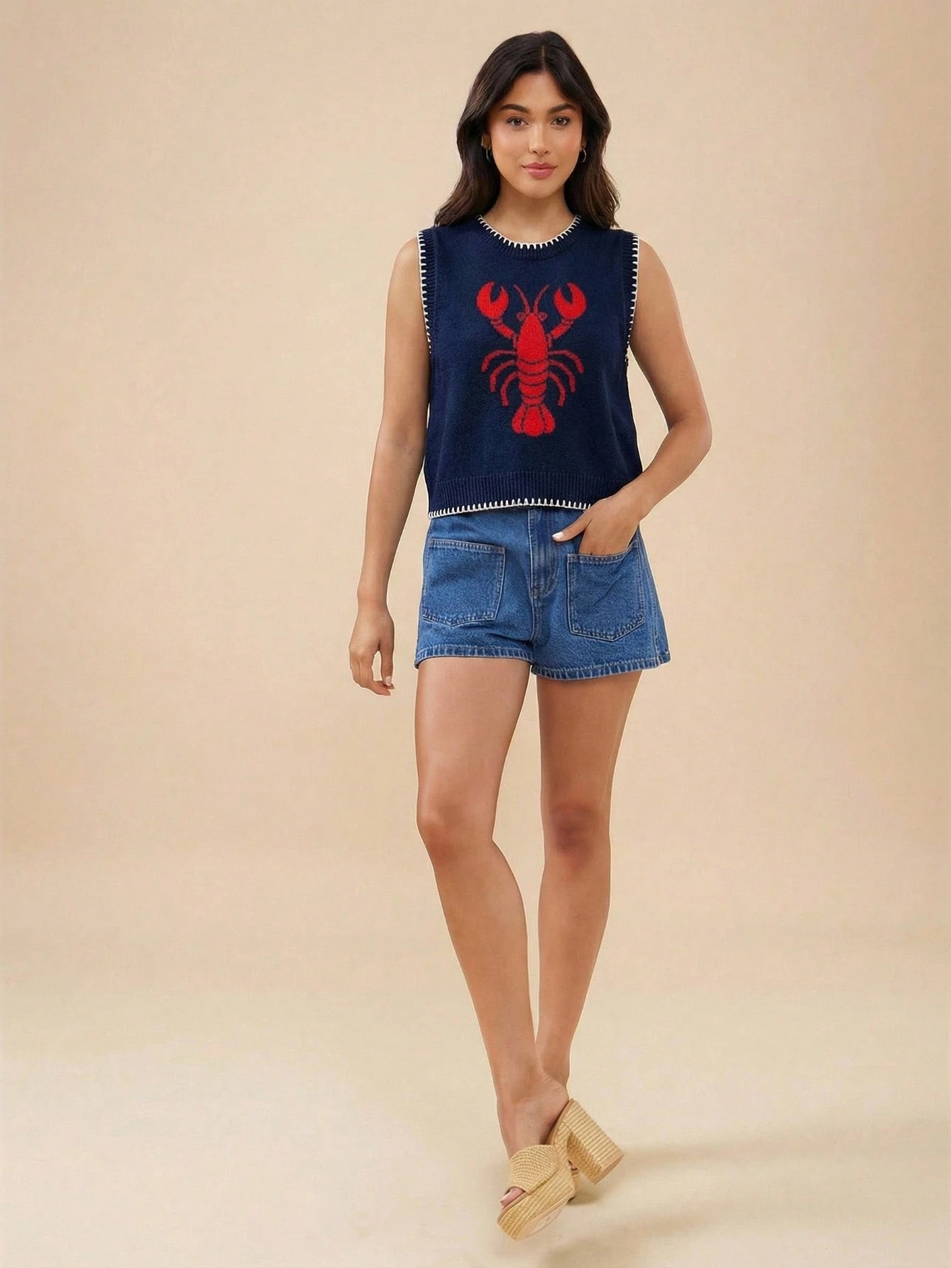 Women's jacquard knit vest in Black Apricot – close-up of embroidered pattern and round neckline