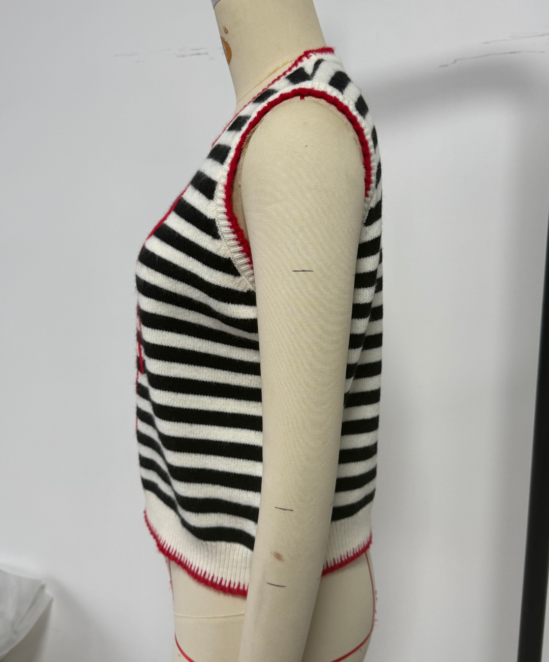 Women's sleeveless knit vest in Black Apricot – styled for evening with midi skirt and heels