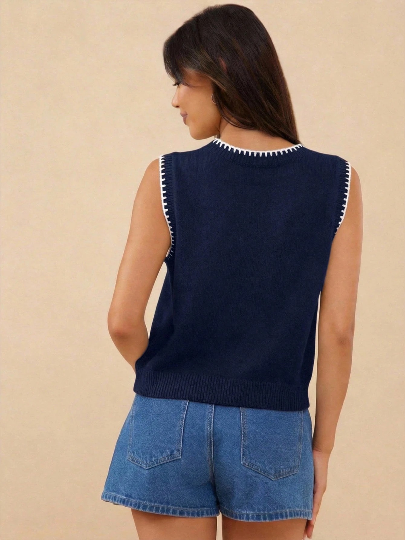 Women's knit pullover vest in White Blue – lifestyle photo showing fit and embroidery detail