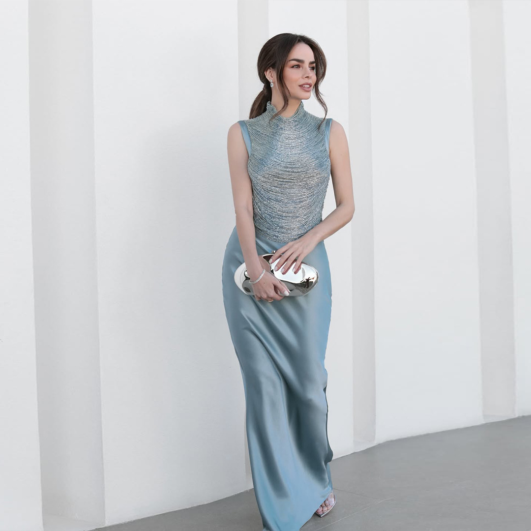Sleeveless Turtleneck Top With Tassel Detailing Paired With A Satin Midi Skirt