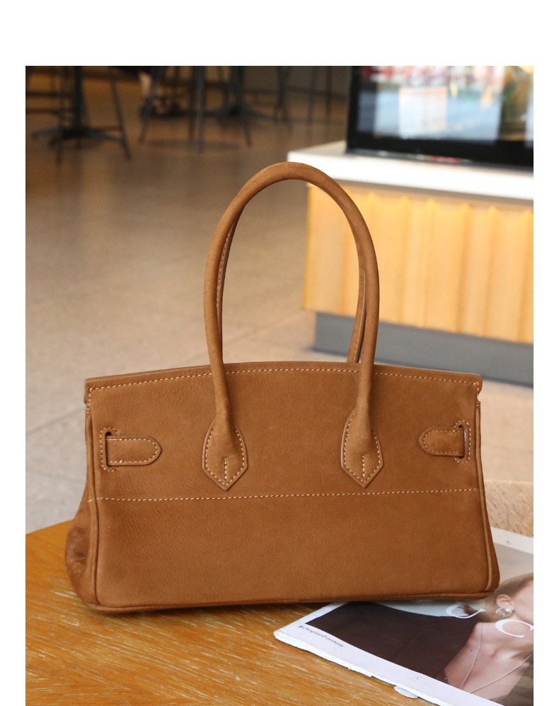 Rear view of the tea-brown top-handle bag showing the matte surface, stitching and handle attachments
