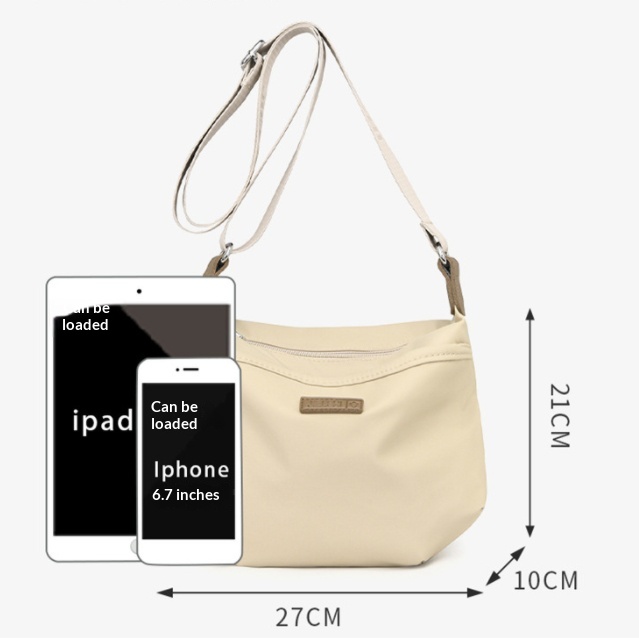 Cream shoulder bag with adjustable strap, showing dimensions of 27 cm wide, 21 cm high and 10 cm deep