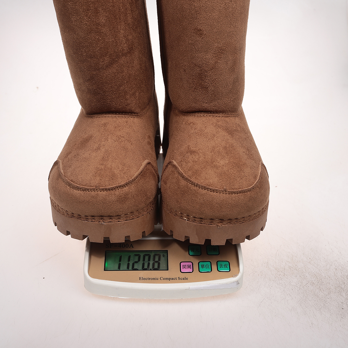Actual brown suede-look boots showing rounded toes, curved seams and chunky treaded soles