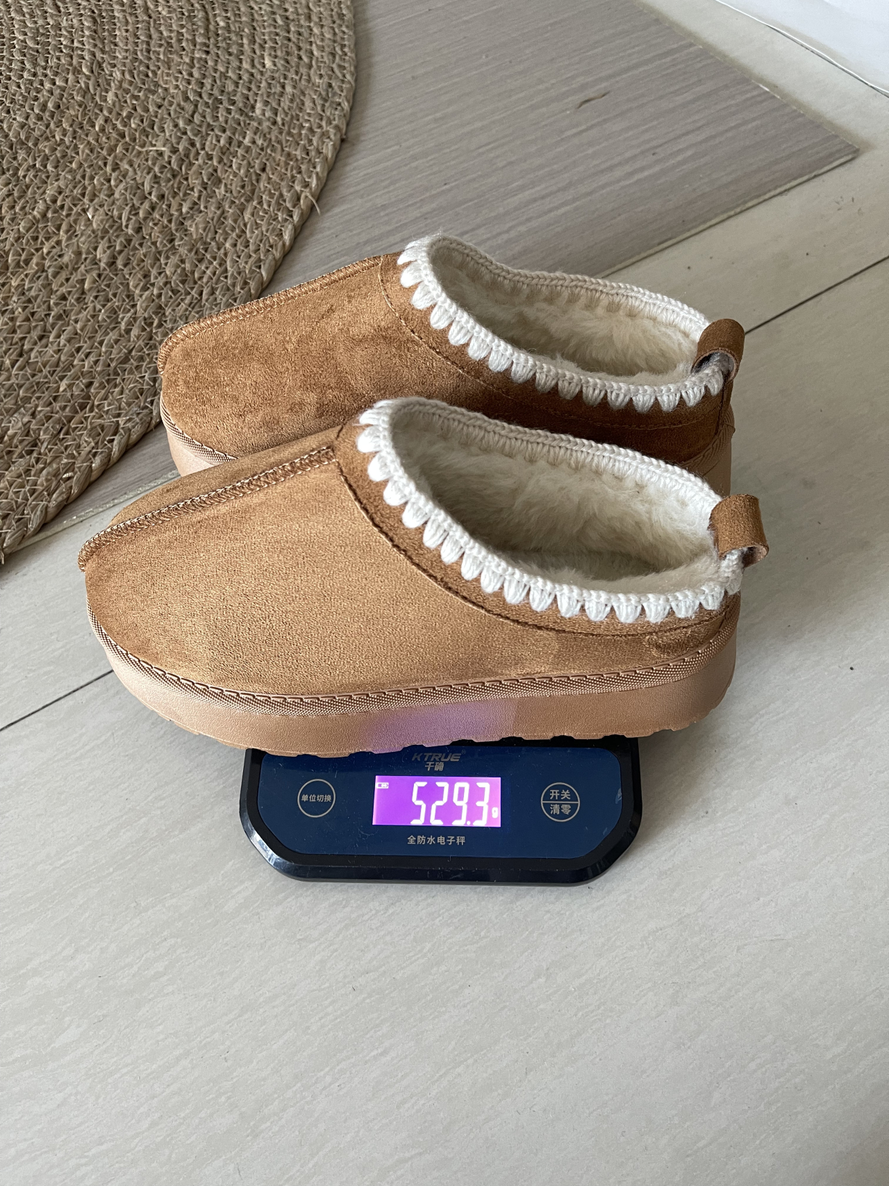 Actual brown platform slip-on shoes showing plush lining, white contrast stitching and rear pull tabs